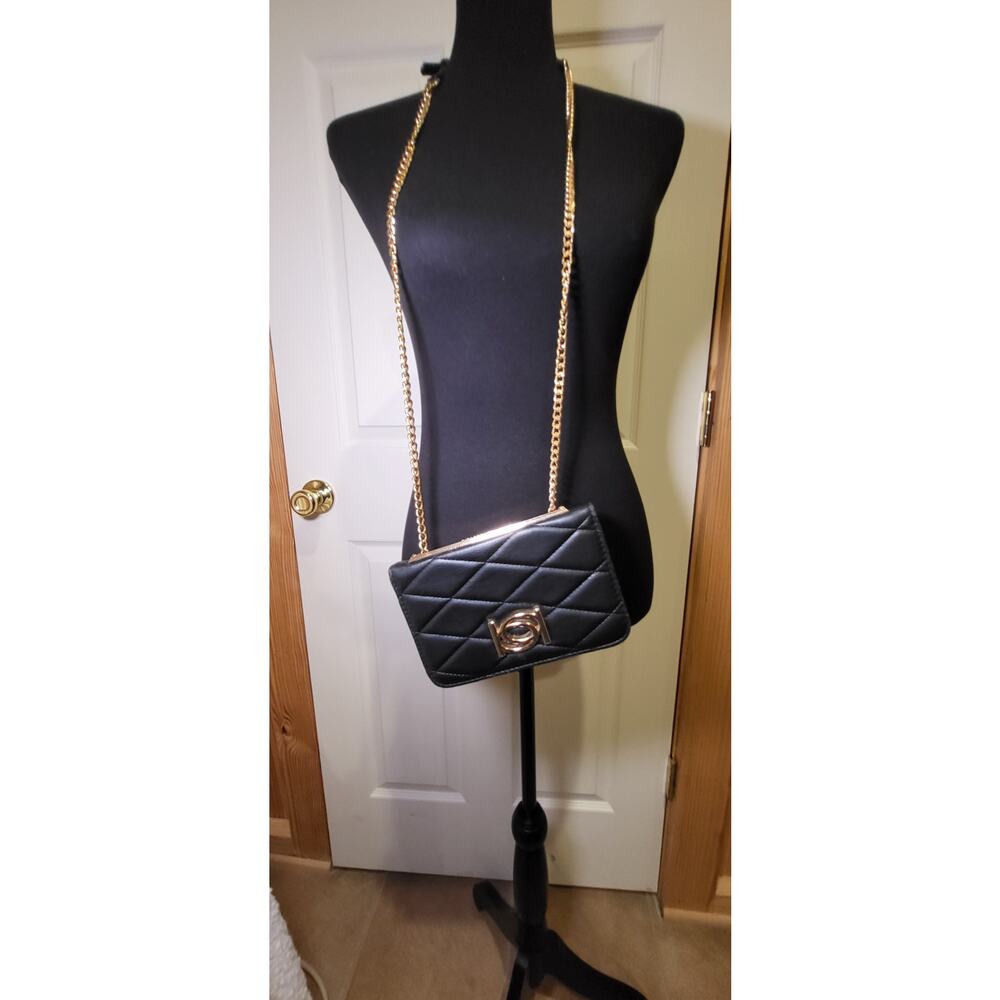 BeBe Crossbody purse, black, long gold color strap, divided sections.